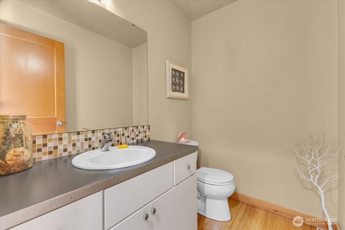 1719 Southwest Henderson Street Seattle, WA 98106 - Photo 10 of 22 a bathroom with a sink a toilet and a mirror