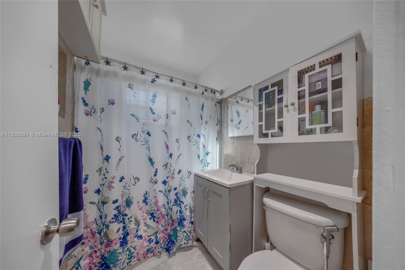 1334 Southwest 4th Street Miami, FL 33135 - Photo 12 of 46 a bathroom with a toilet and a shower curtain