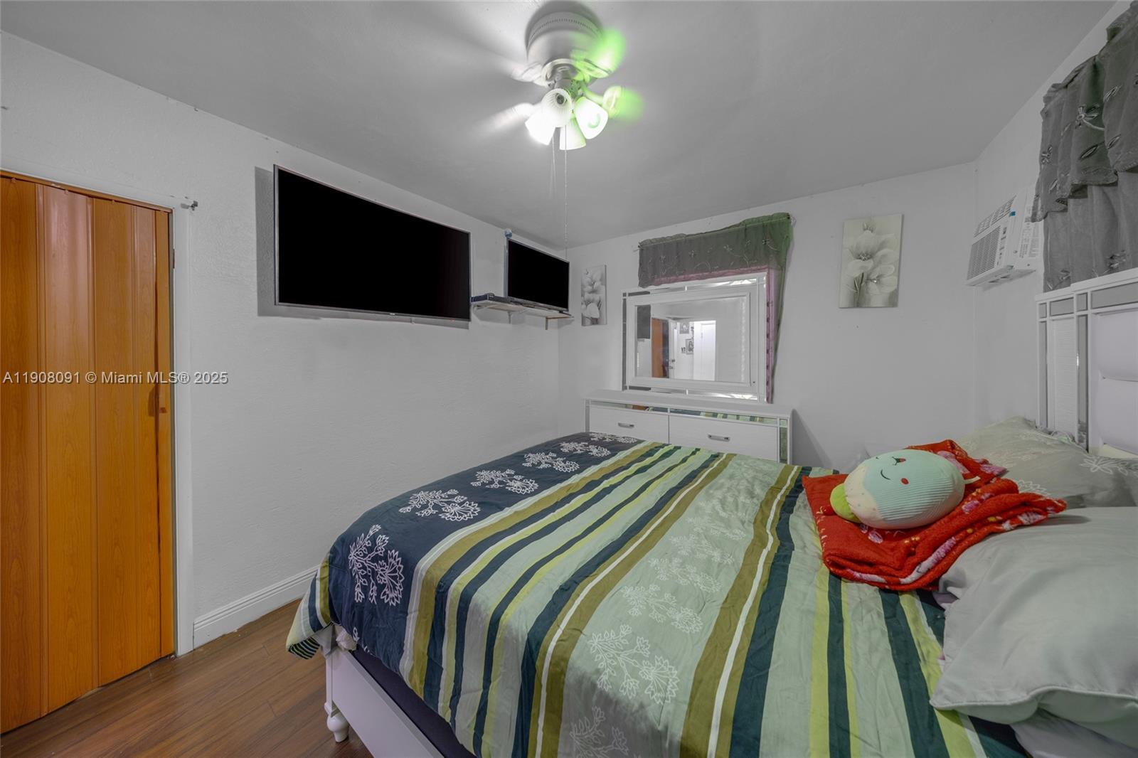 1334 Southwest 4th Street Miami, FL 33135 - Photo 14 of 46 a bedroom with a bed and a chandelier