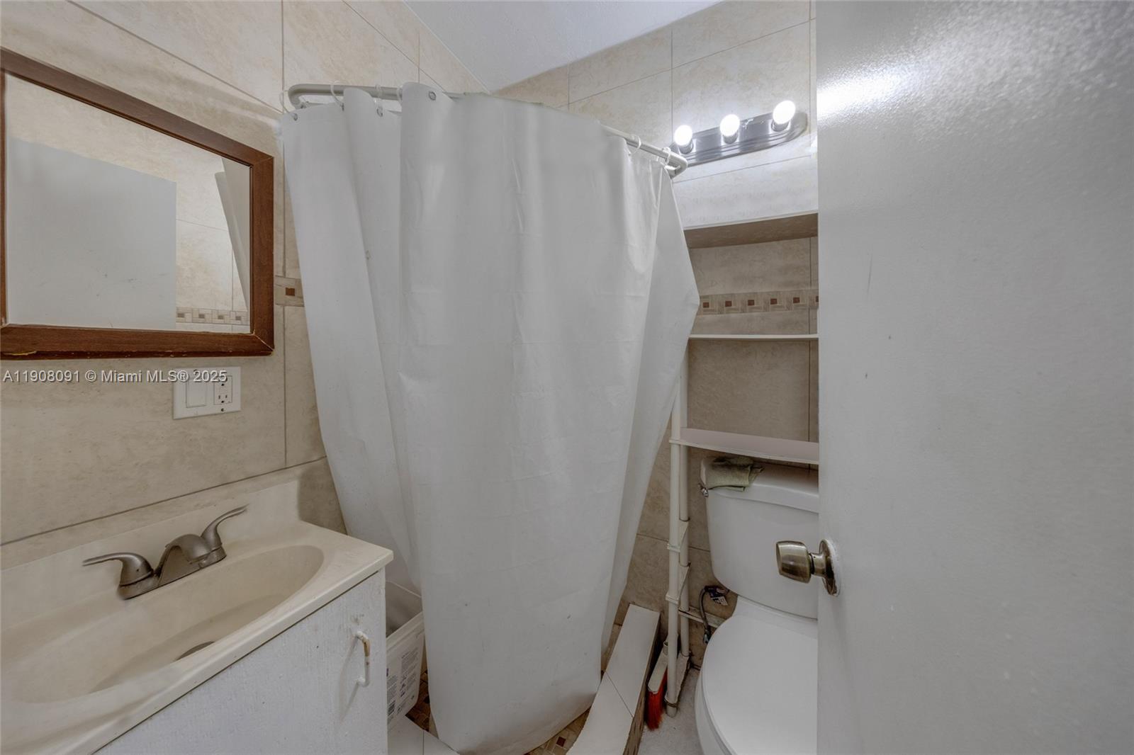 1334 Southwest 4th Street Miami, FL 33135 - Photo 19 of 46 a bathroom with a sink a toilet and shower