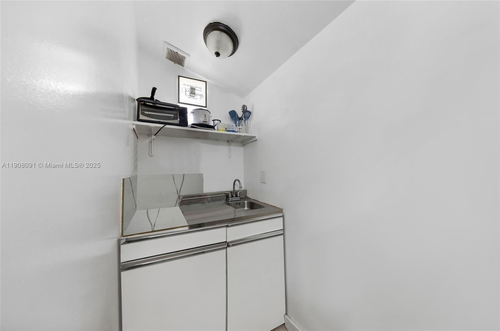 1334 Southwest 4th Street Miami, FL 33135 - Photo 28 of 46 a kitchen with stainless steel appliances a sink and cabinets