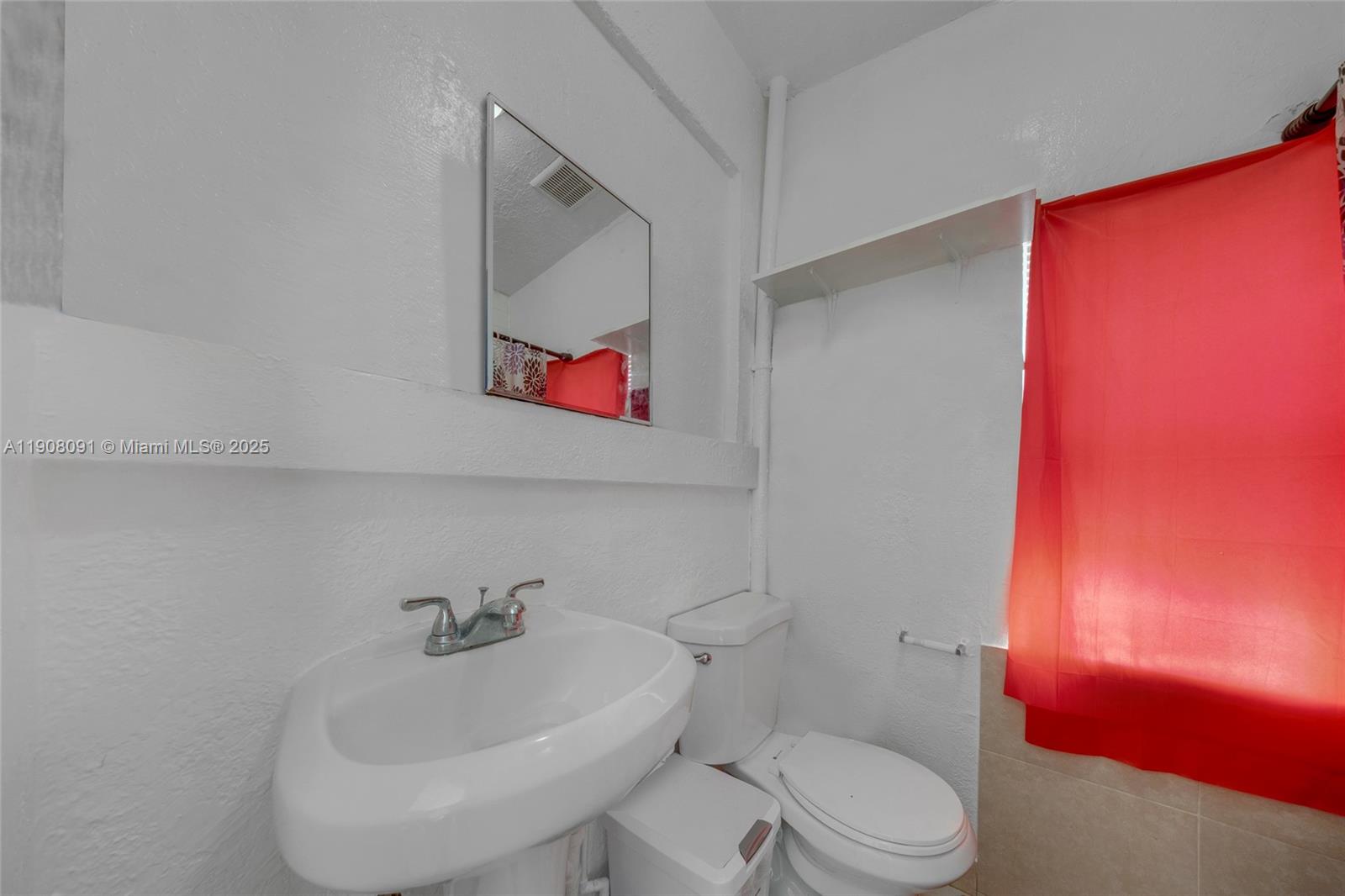 1334 Southwest 4th Street Miami, FL 33135 - Photo 32 of 46 a white toilet sitting next to a bathroom sink