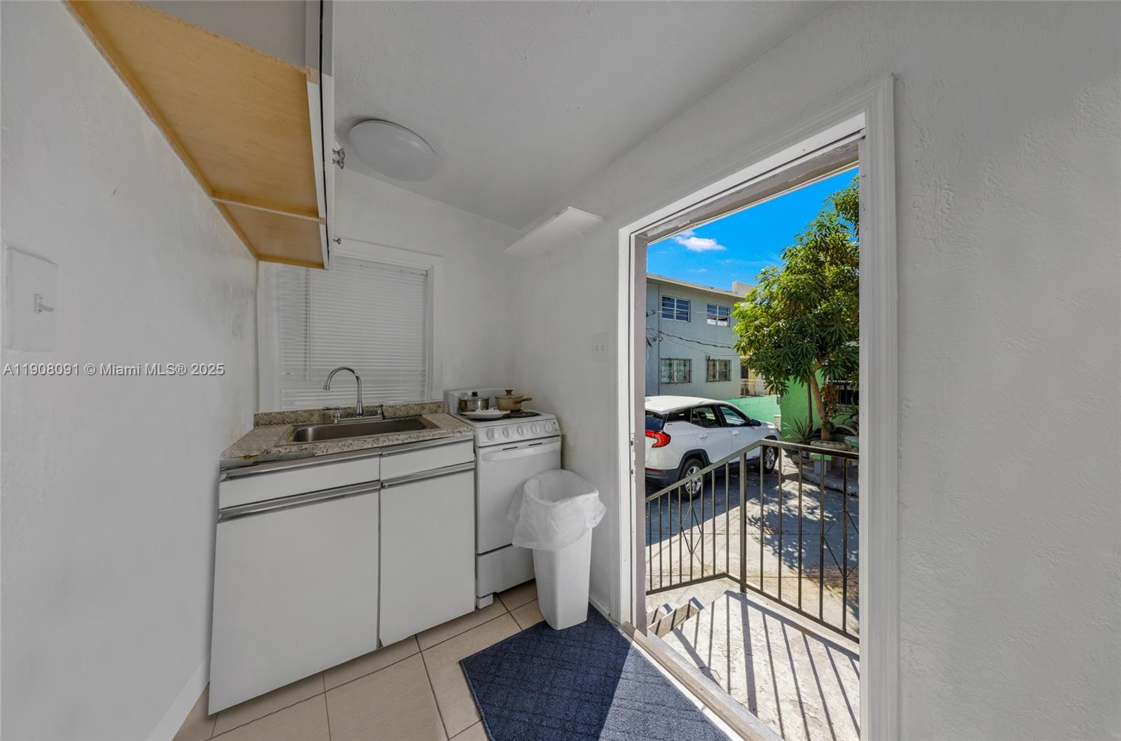 1334 Southwest 4th Street Miami, FL 33135 - Photo 33 of 46 a kitchen with a sink and a stove top oven