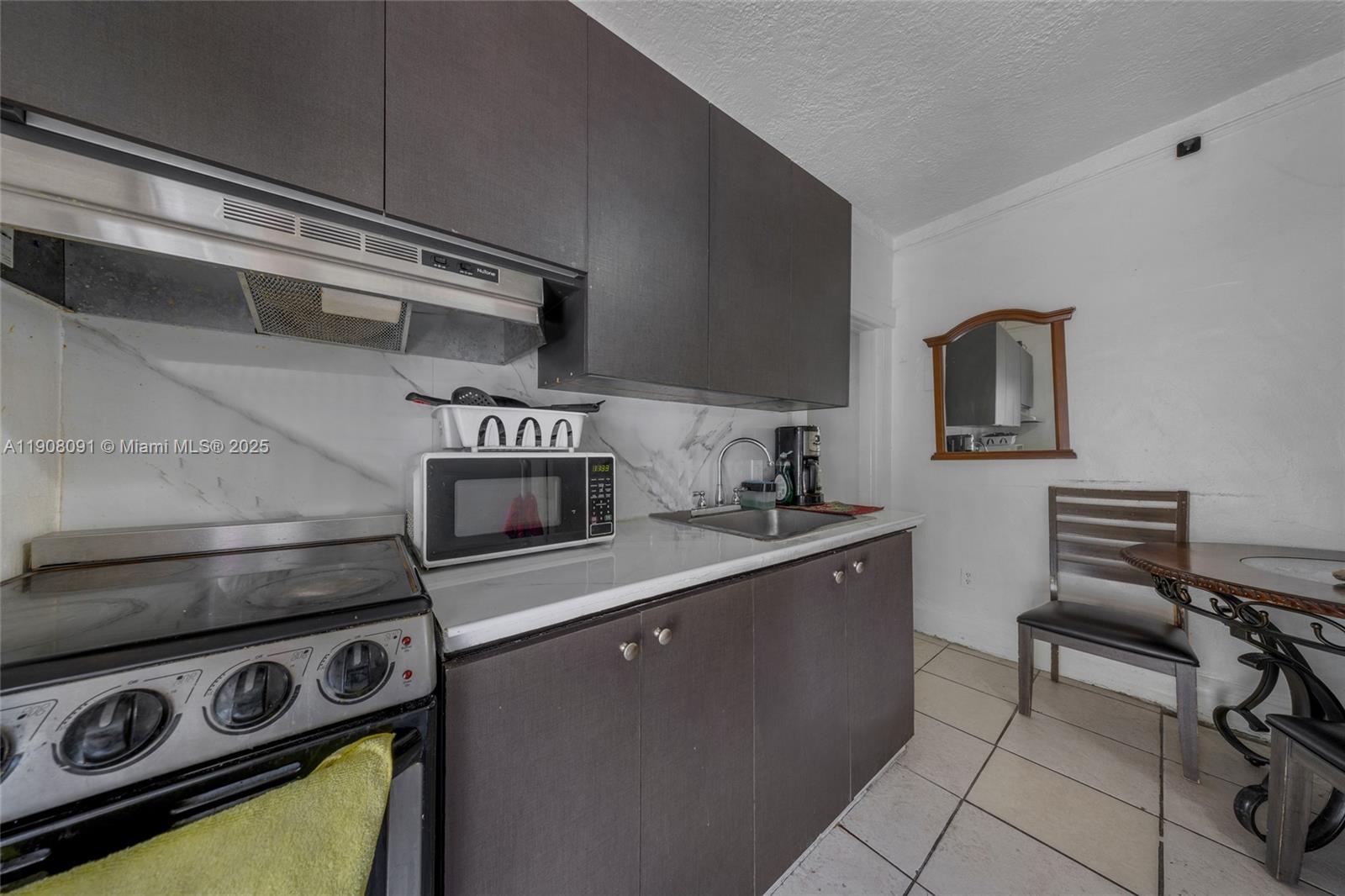 1334 Southwest 4th Street Miami, FL 33135 - Photo 39 of 46 a kitchen with stainless steel appliances a stove and a refrigerator