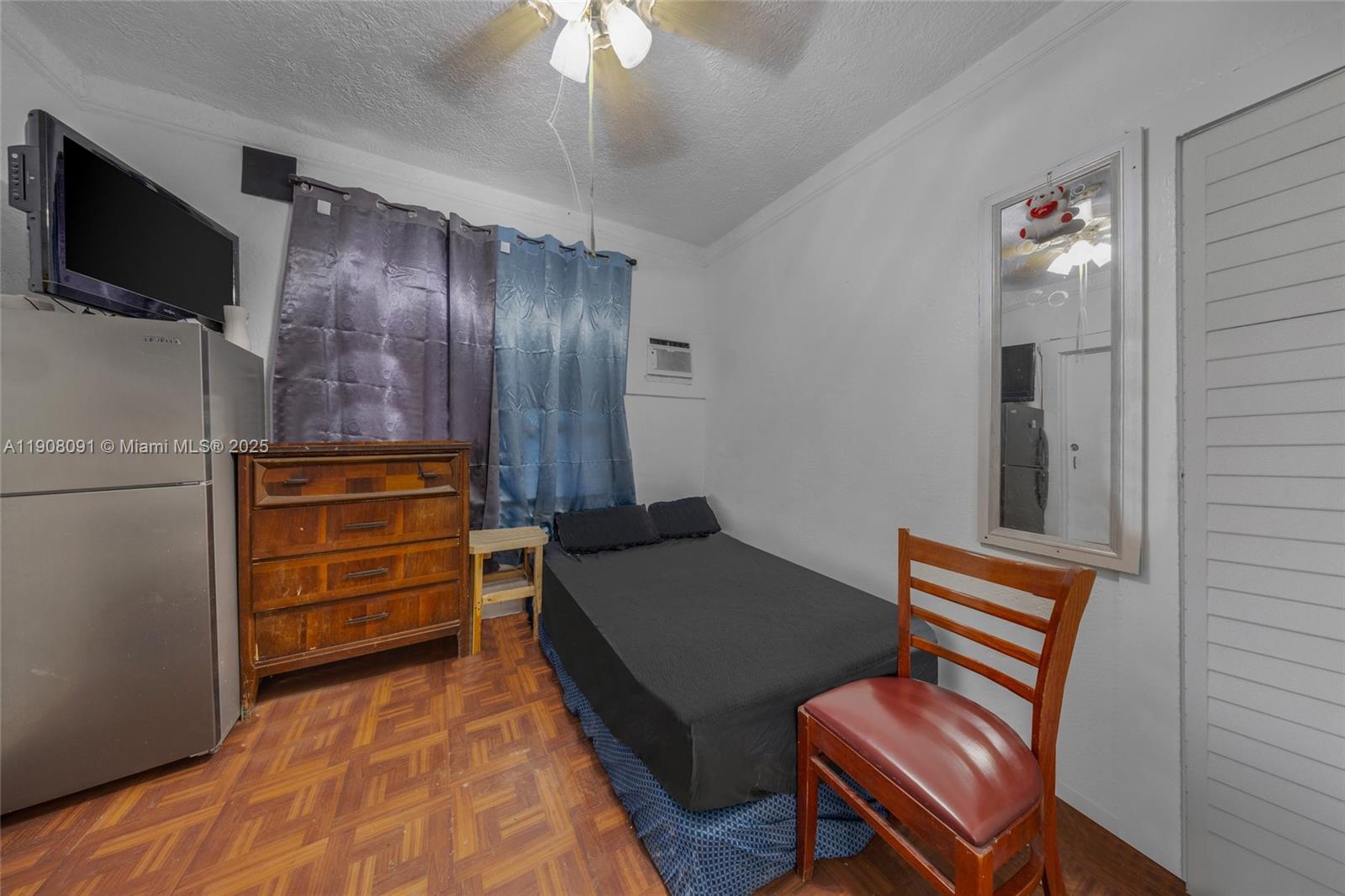 1334 Southwest 4th Street Miami, FL 33135 - Photo 42 of 46 a bedroom with furniture and a flat screen tv