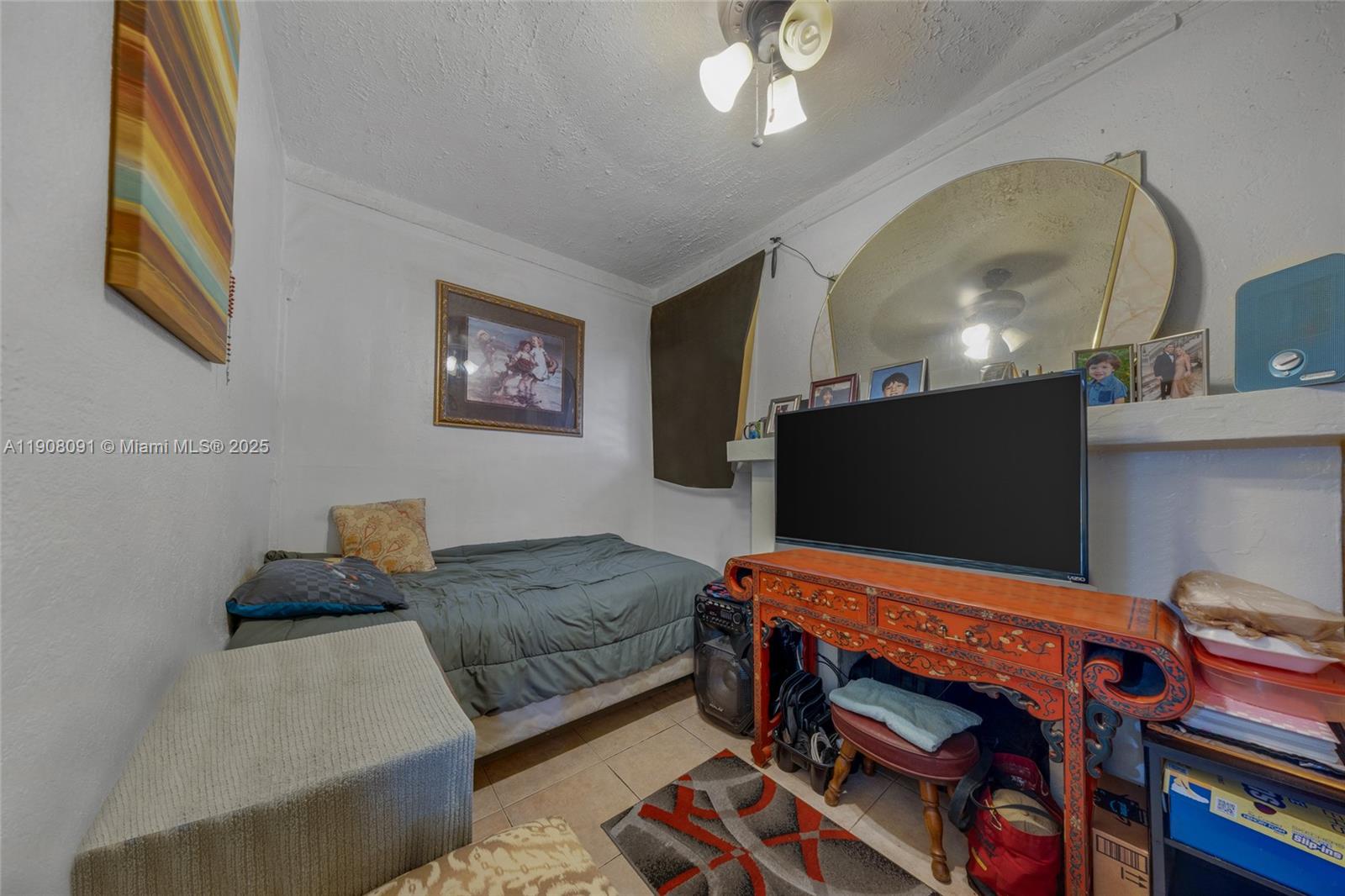 1334 Southwest 4th Street Miami, FL 33135 - Photo 43 of 46 a bedroom with furniture and a flat screen tv