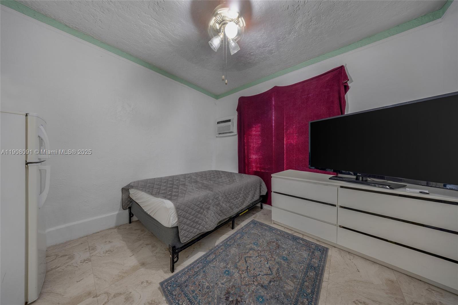 1334 Southwest 4th Street Miami, FL 33135 - Photo 45 of 46 a bedroom with a bed and a flat screen tv