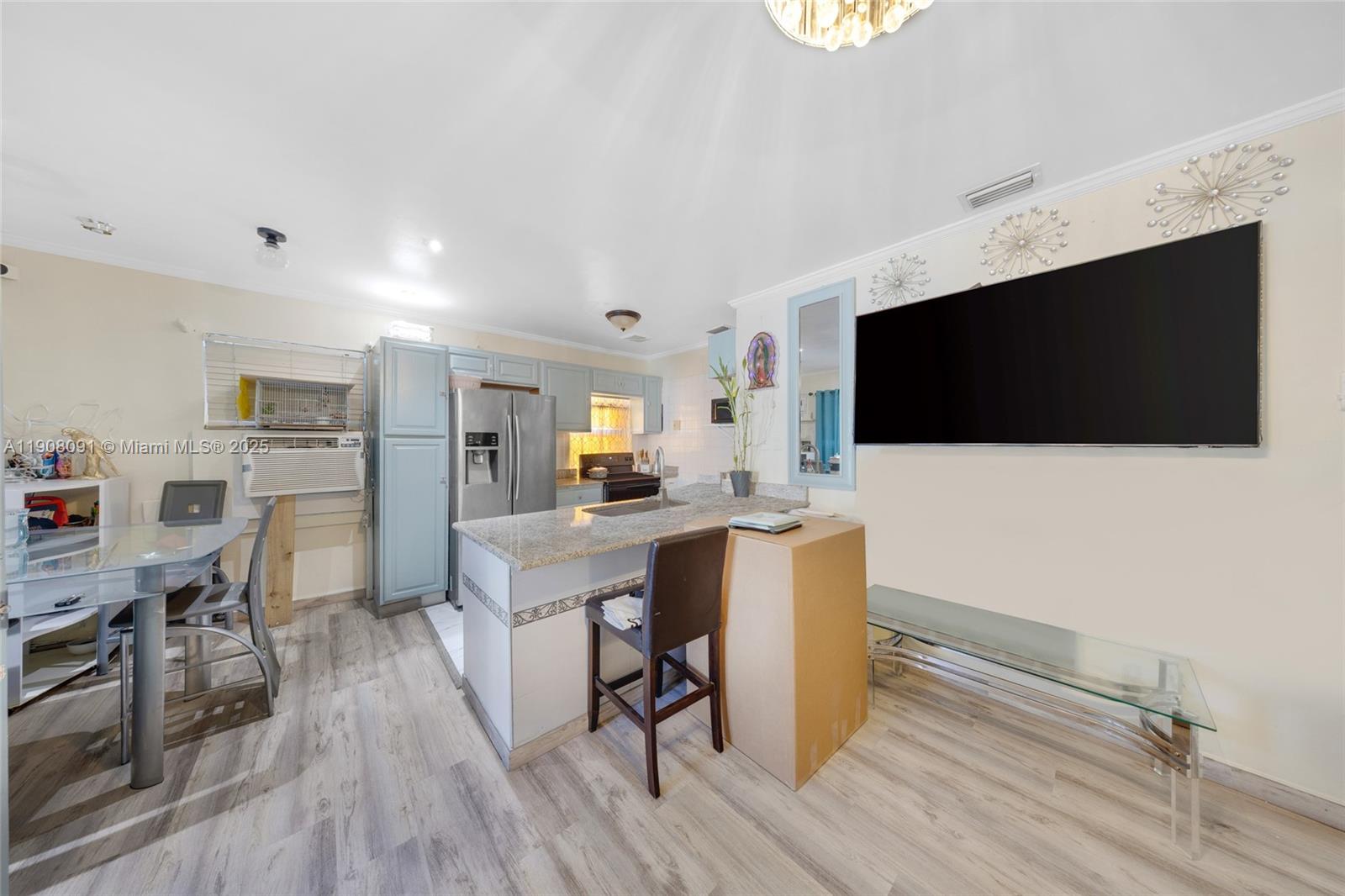 1334 Southwest 4th Street Miami, FL 33135 - Photo 7 of 46 a living room with furniture and a flat screen tv