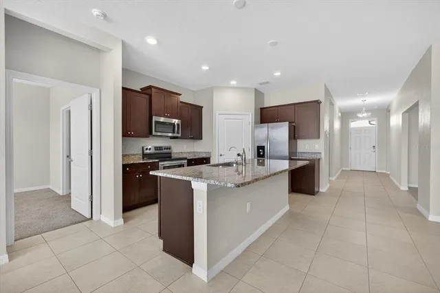 a large kitchen with stainless steel appliances lots of counter top space