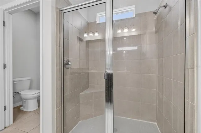 a bathroom with a glass shower door