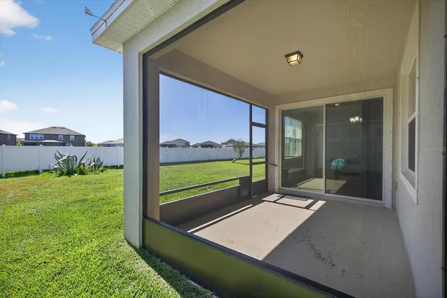a view of an house with backyard and porch