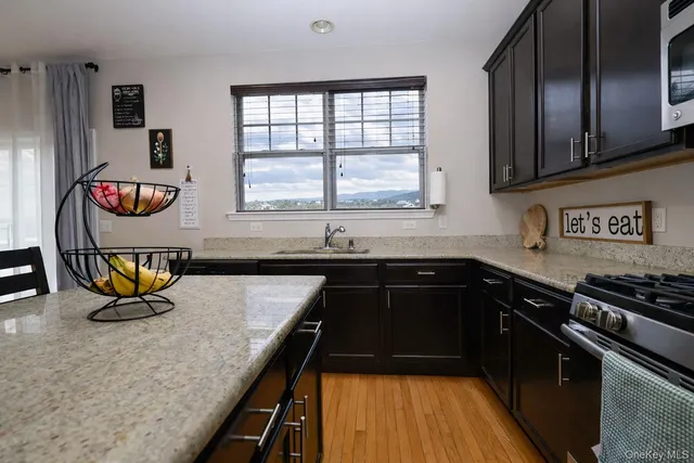 a kitchen with a sink and a stove top oven