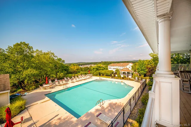 a view of a swimming pool with a lounge chairs