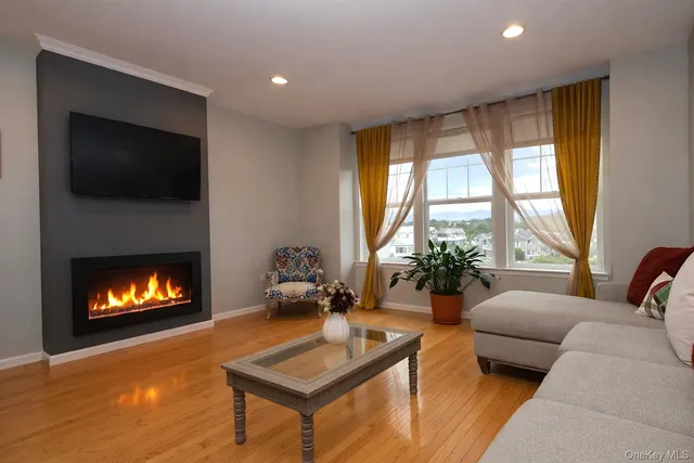a living room with furniture flat screen tv and a fireplace