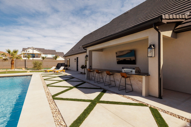 2281 South Crimson Cliffs Way St. George, UT 84790 - Photo 9 of 47 View of swimming pool featuring patio surround and outdoor kitchen