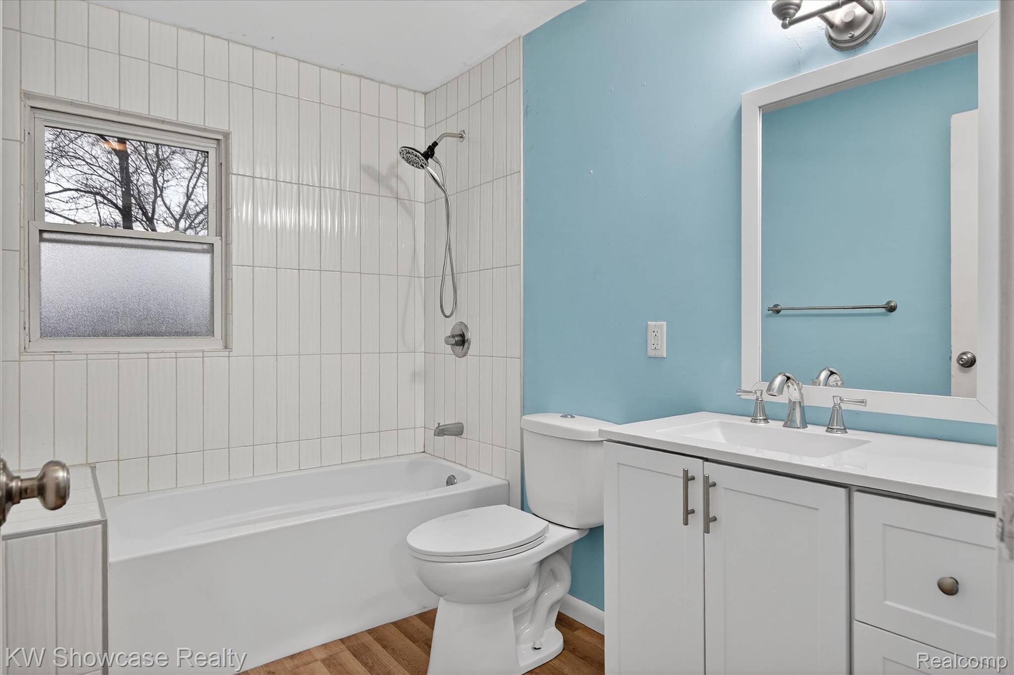 1860 Ladd Road Walled Lake, MI 48390 - Photo 23 of 48 Full bathroom featuring shower combination, vanity, and light wood-type flooring