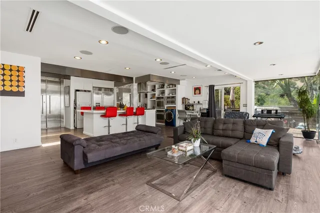 a living room with furniture and kitchen view