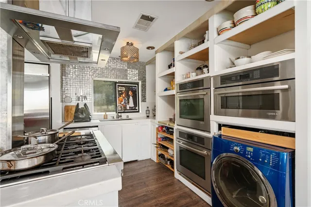 a kitchen with a stove and a microwave