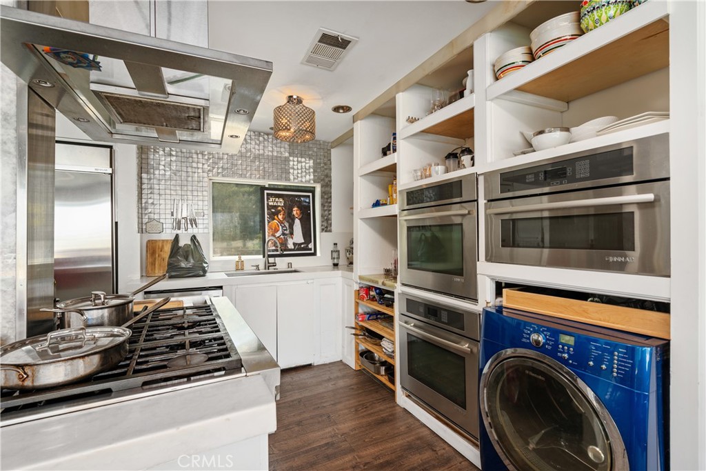 7241 Woodrow Wilson Drive Los Angeles, CA 90068 - Photo 14 of 43 a kitchen with a stove and a microwave