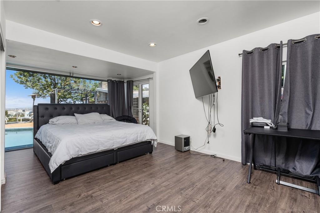 7241 Woodrow Wilson Drive Los Angeles, CA 90068 - Photo 17 of 43 a bedroom with a bed window and dresser