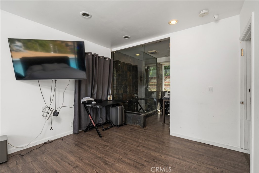 7241 Woodrow Wilson Drive Los Angeles, CA 90068 - Photo 19 of 43 a view of a livingroom with furniture and gym equipment