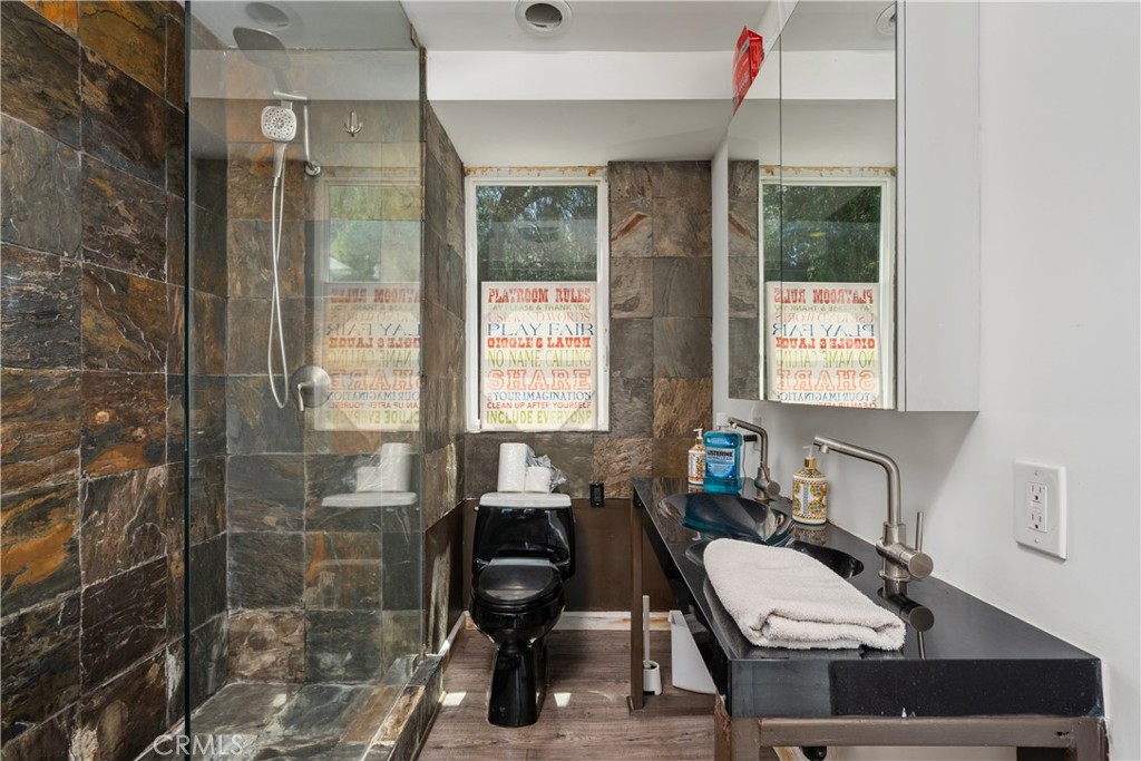 7241 Woodrow Wilson Drive Los Angeles, CA 90068 - Photo 21 of 43 a bathroom with a sink a toilet and shower
