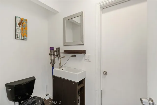 a view of a roof deck with table and chairs with wooden floor and plants