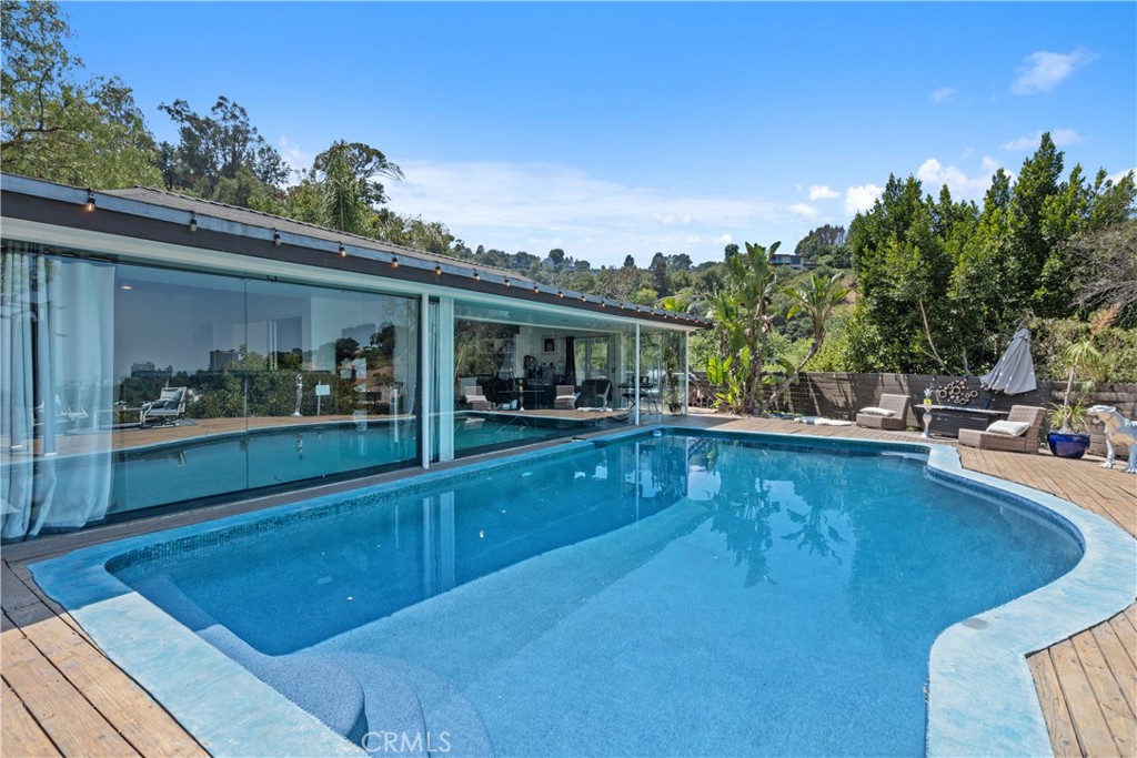 7241 Woodrow Wilson Drive Los Angeles, CA 90068 - Photo 28 of 43 a view of a swimming pool with an outdoor seating