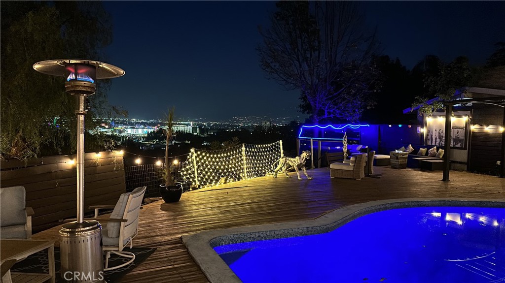 7241 Woodrow Wilson Drive Los Angeles, CA 90068 - Photo 30 of 43 a view of a patio with table and chairs potted plants