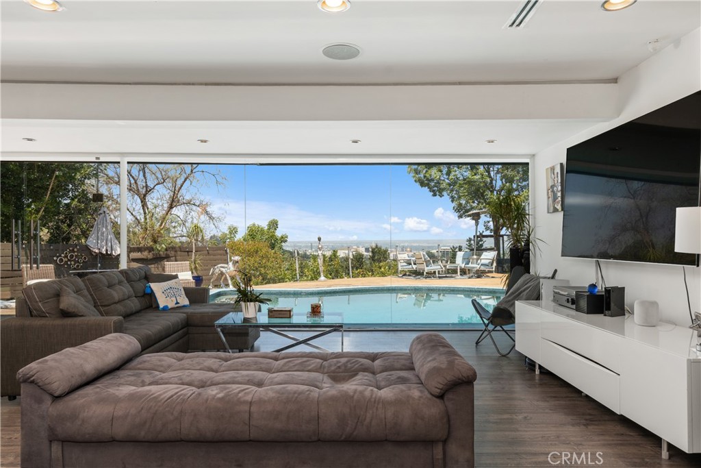 7241 Woodrow Wilson Drive Los Angeles, CA 90068 - Photo 3 of 43 a living room with furniture and a flat screen tv