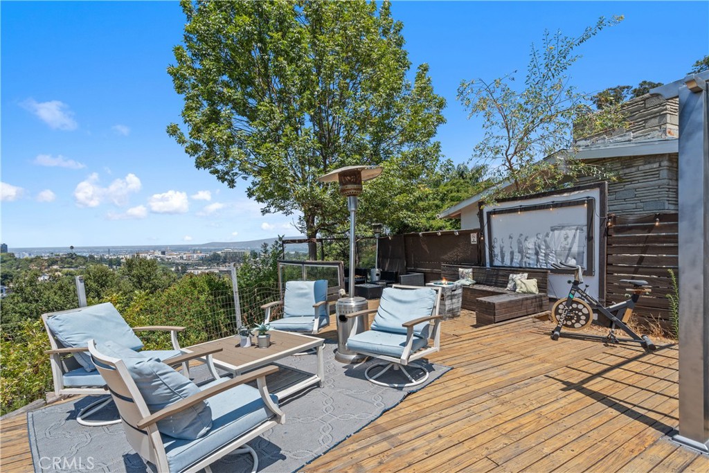 7241 Woodrow Wilson Drive Los Angeles, CA 90068 - Photo 31 of 43 a view of a patio with a table and chairs