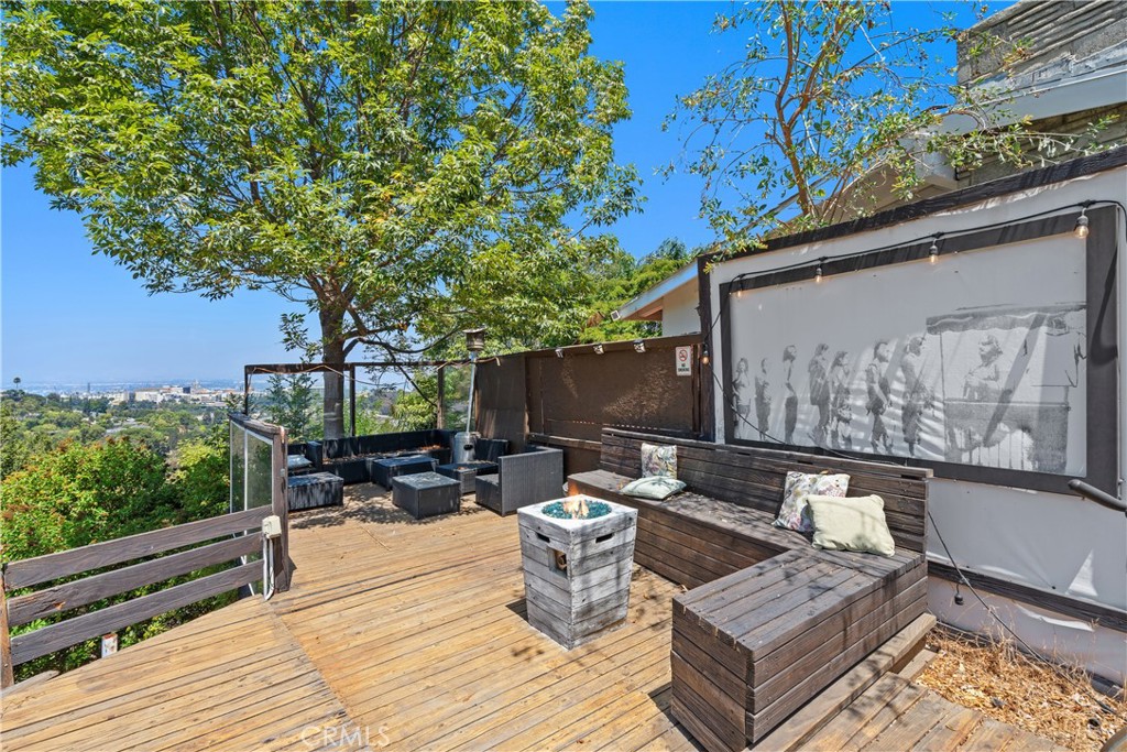 7241 Woodrow Wilson Drive Los Angeles, CA 90068 - Photo 32 of 43 a backyard of a house with wooden floor and outdoor seating