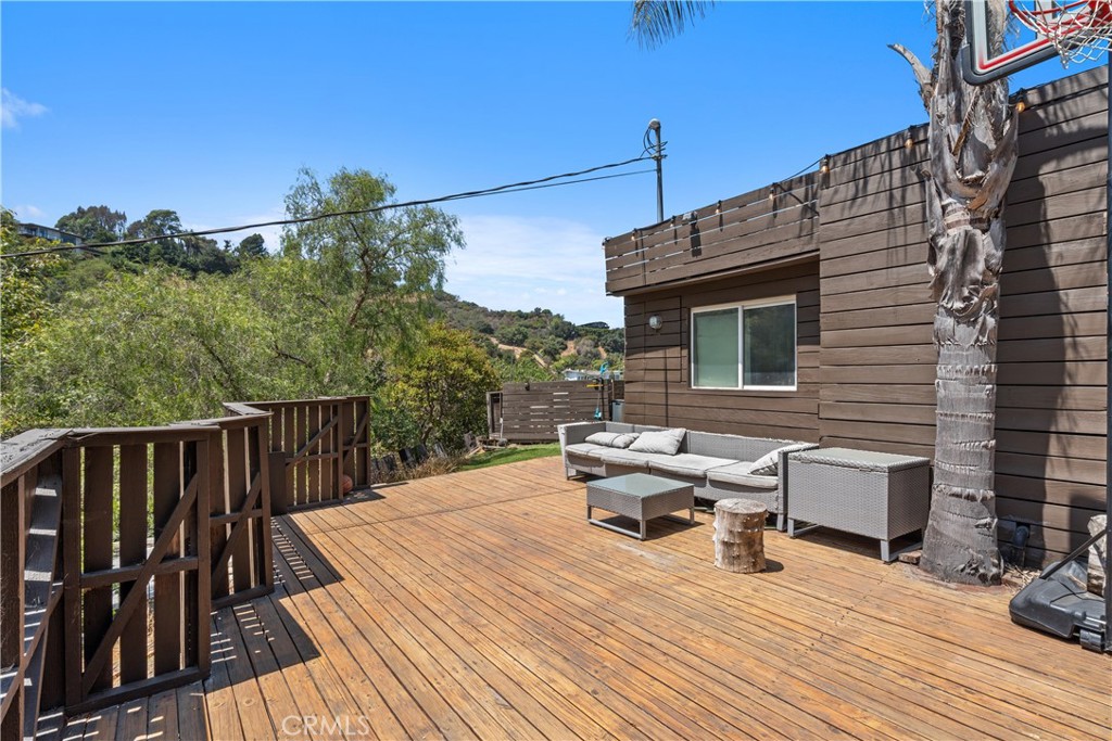 7241 Woodrow Wilson Drive Los Angeles, CA 90068 - Photo 41 of 43 a roof deck with wooden floor and fence