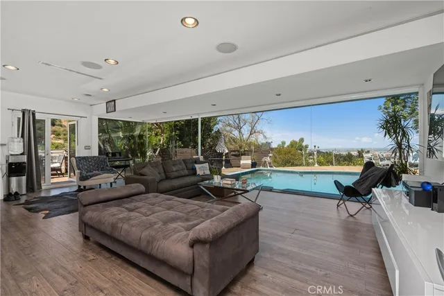 a living room with patio furniture and a flat screen tv