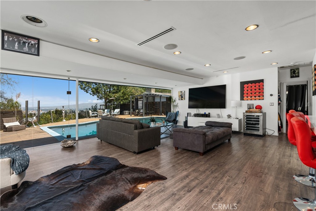 7241 Woodrow Wilson Drive Los Angeles, CA 90068 - Photo 8 of 43 a living room with furniture and a flat screen tv