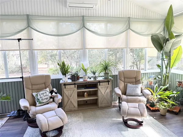 a living room with lots of furniture and a large window