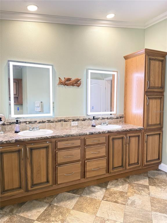 8261 Northeast 118 Terrace Bronson, FL 32621 - Photo 15 of 43 a bathroom with a sink and a mirror