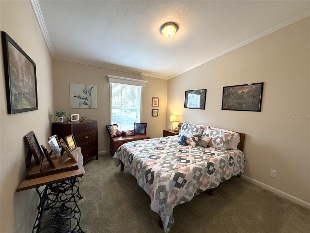 8261 Northeast 118 Terrace Bronson, FL 32621 - Photo 20 of 43 a bedroom with bed and a couch
