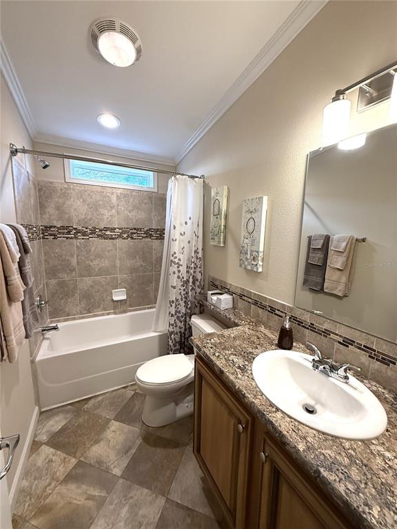 8261 Northeast 118 Terrace Bronson, FL 32621 - Photo 21 of 43 a bathroom with a granite countertop sink toilet and shower