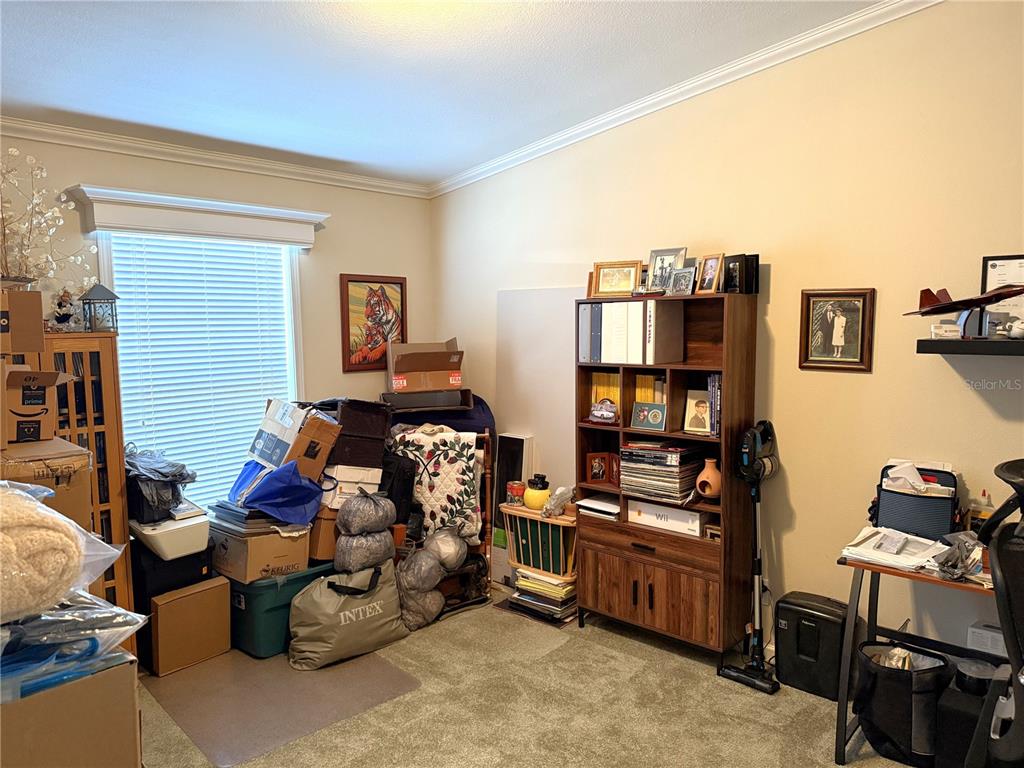 8261 Northeast 118 Terrace Bronson, FL 32621 - Photo 22 of 43 a bedroom with furniture and a book shelf