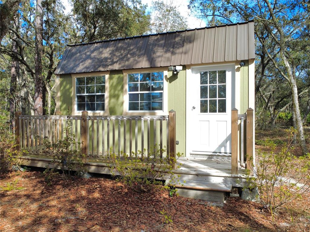 8261 Northeast 118 Terrace Bronson, FL 32621 - Photo 27 of 43 front view of a house with a small yard