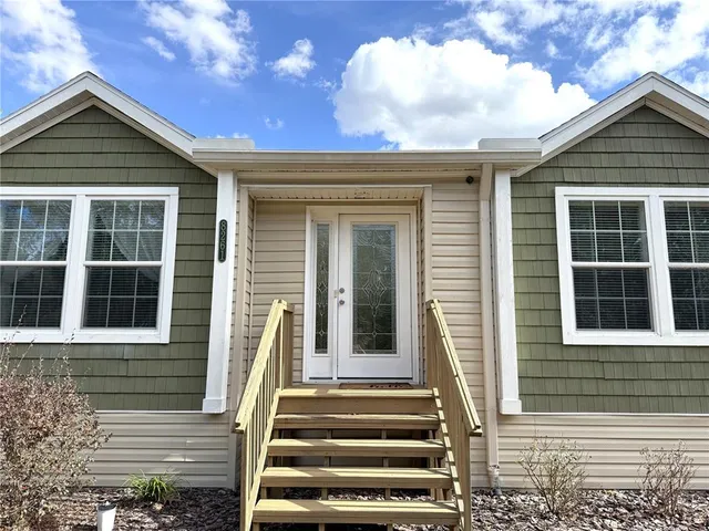 an aerial view of a house with table and chairs