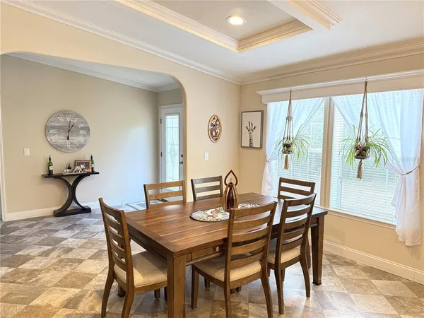 a view of a dining room with furniture and a large window