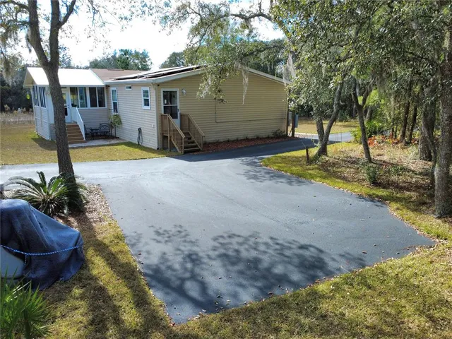 an aerial view of house with yard and outdoor seating