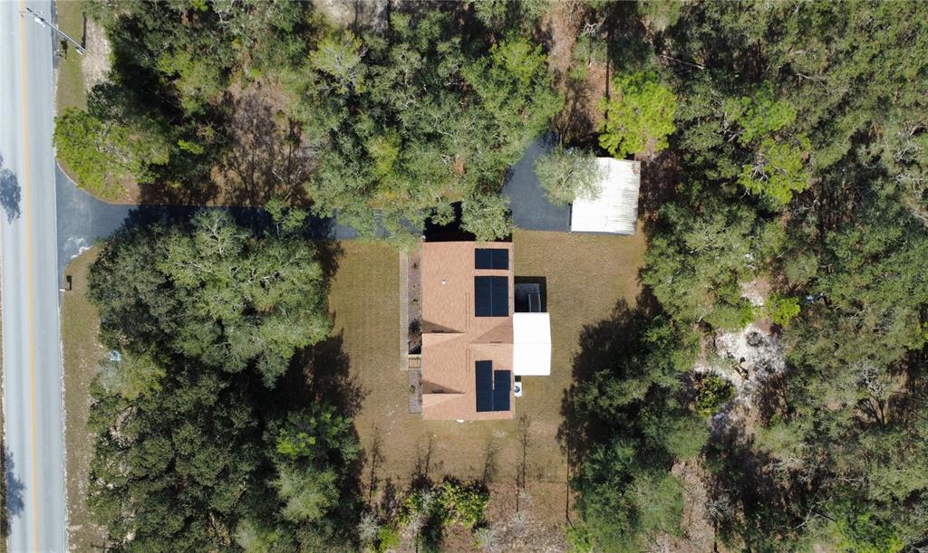 8261 Northeast 118 Terrace Bronson, FL 32621 - Photo 37 of 43 an aerial view of house with yard and outdoor seating