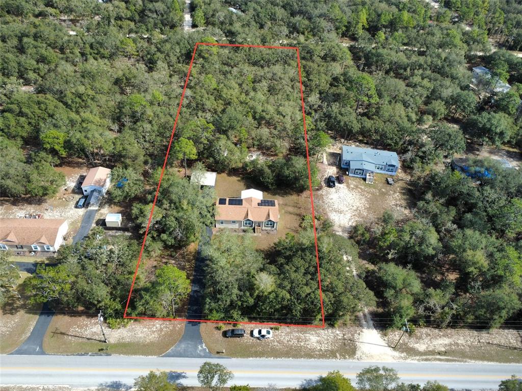 8261 Northeast 118 Terrace Bronson, FL 32621 - Photo 38 of 43 an aerial view of a house with a yard
