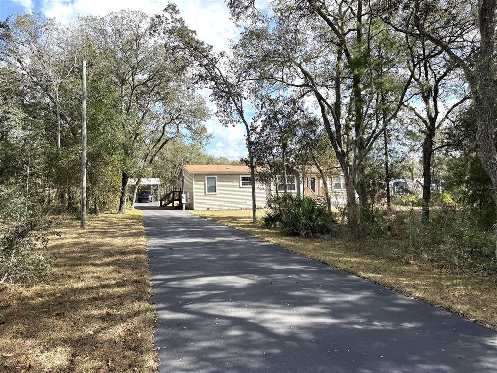 8261 Northeast 118 Terrace Bronson, FL 32621 - Photo 42 of 43 a view of a house with a yard and tree s