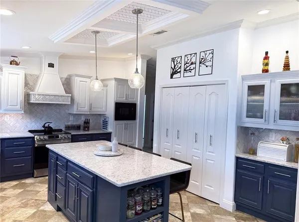 a kitchen with stainless steel appliances granite countertop a sink a stove and a refrigerator
