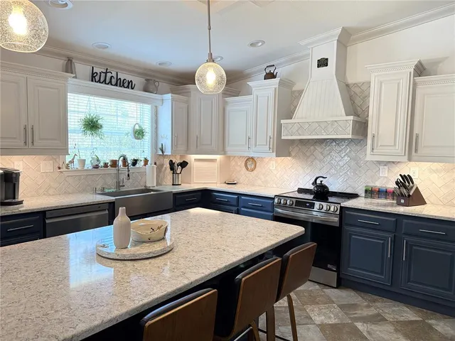 a kitchen with a sink a stove and wooden cabinets