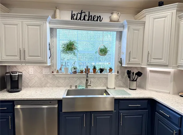 a kitchen with stainless steel appliances granite countertop a sink and cabinets